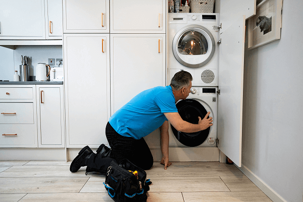 Male engineer repairing a washing machine