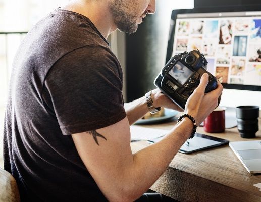 Man editing photos from a canon camera