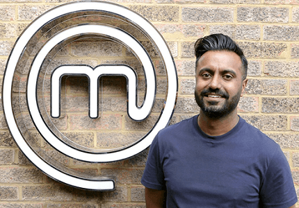 Johnny Banger stood in front of the MasterChef UK sign