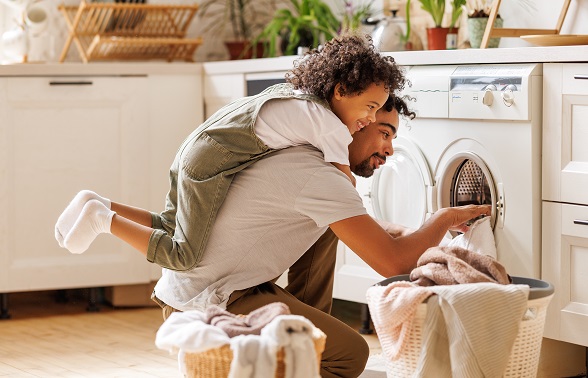 Father and son loading laundry