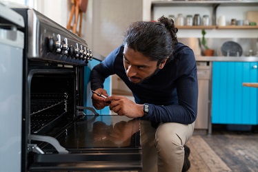 Engineer repairing an oven